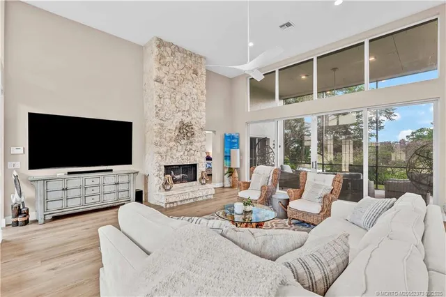 a living room with fireplace furniture and a flat screen tv