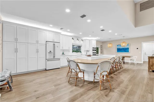 a dining room with furniture and wooden floor
