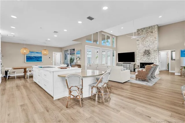 a view of a dining room with furniture a rug and wooden floor