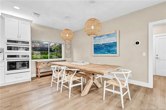 a dining room with furniture and window