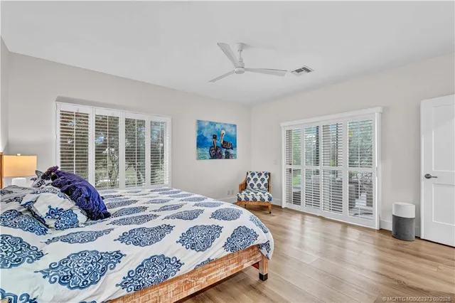 a bedroom with a large bed and a large window