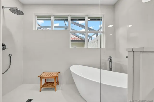 a white bath tub sitting next to a shower