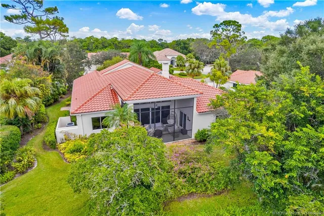 an aerial view of a house with a yard and lake view