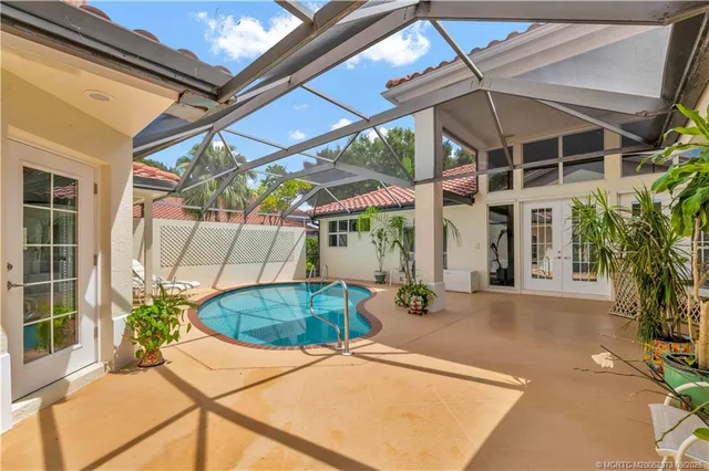 a view of a patio with table and chairs under an umbrella