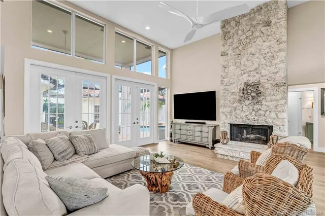 a living room with furniture a flat screen tv and a fireplace