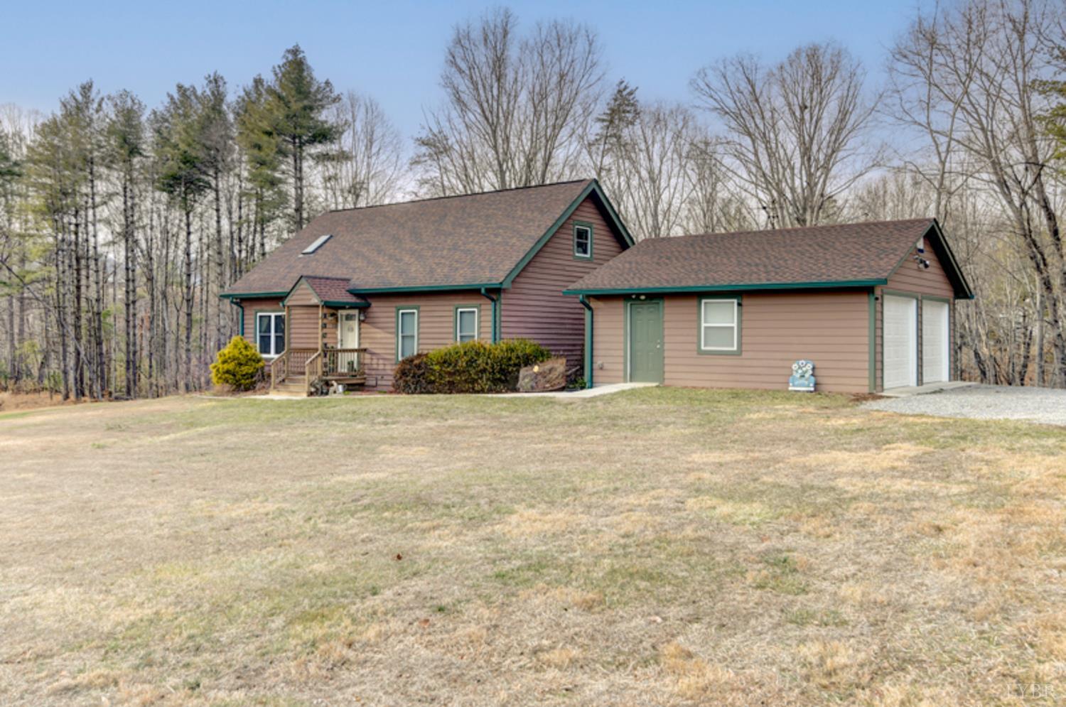223 Cahas Mountain Road Boones Mill, VA 24065 - Photo 2 of 50 a front view of a house with a yard and garage
