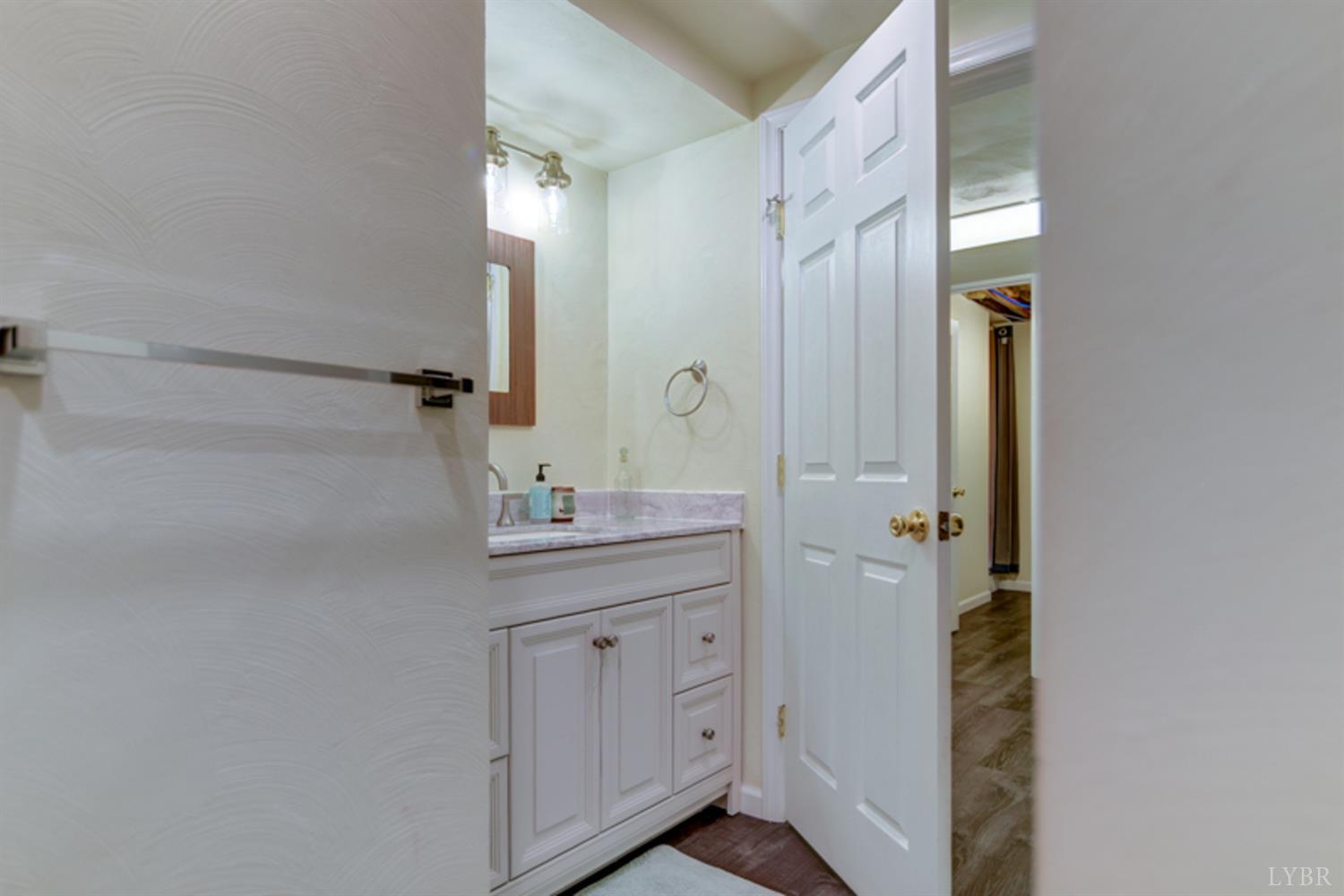 223 Cahas Mountain Road Boones Mill, VA 24065 - Photo 29 of 50 a bathroom with a granite countertop sink and a mirror