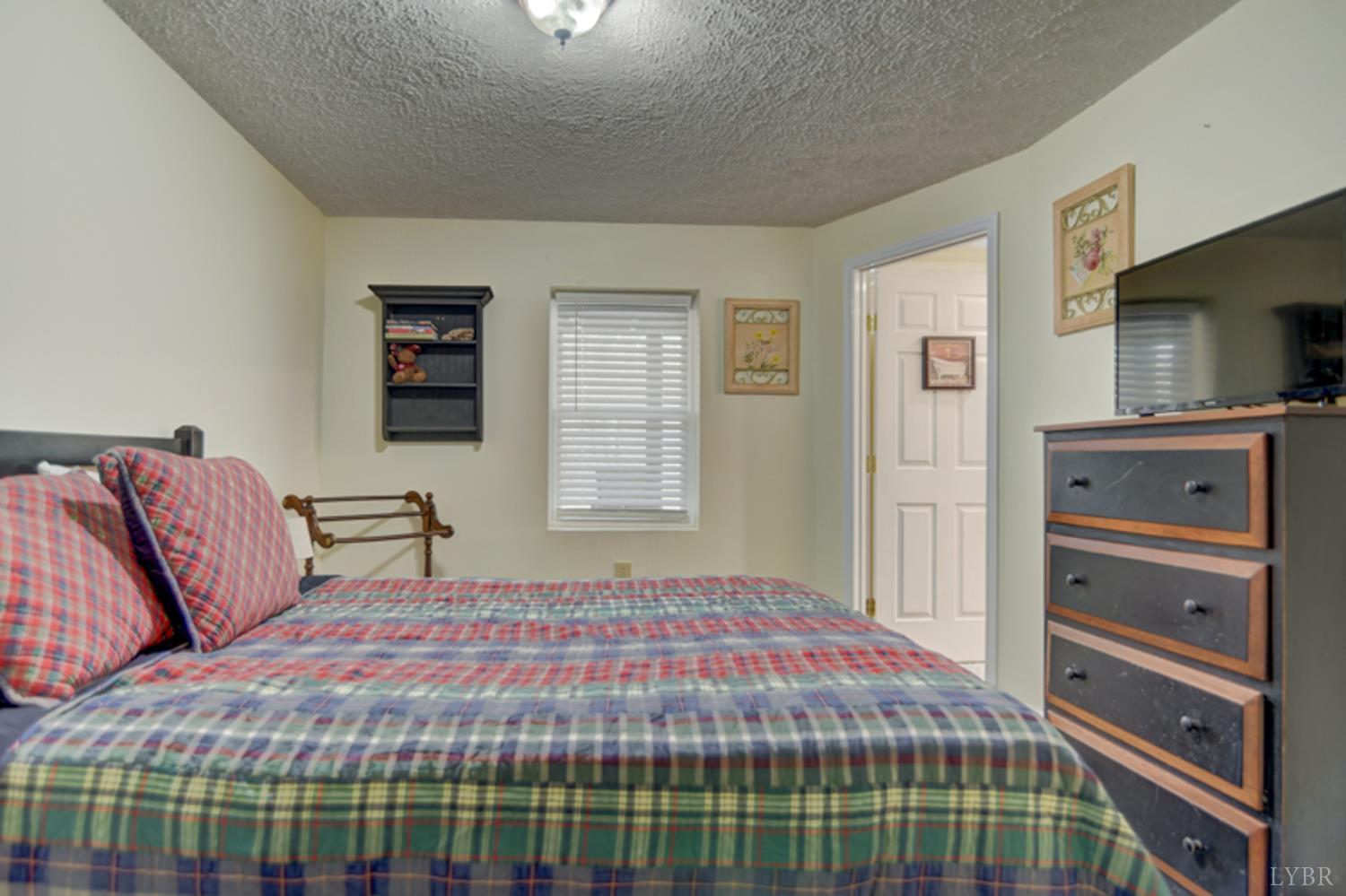 223 Cahas Mountain Road Boones Mill, VA 24065 - Photo 31 of 50 a bedroom with a bed and flat screen tv