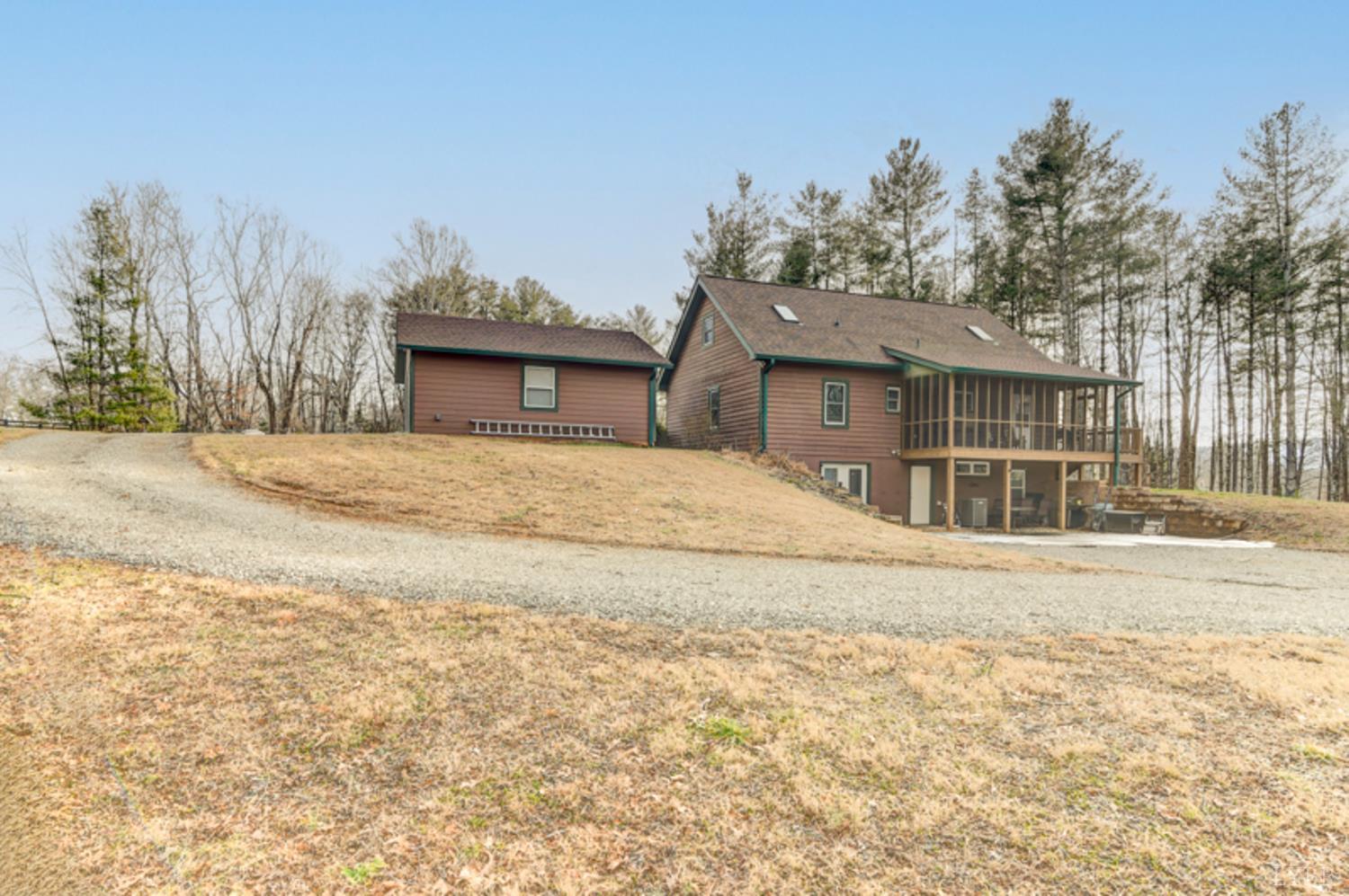 223 Cahas Mountain Road Boones Mill, VA 24065 - Photo 48 of 50 a front view of a house with a yard and garage