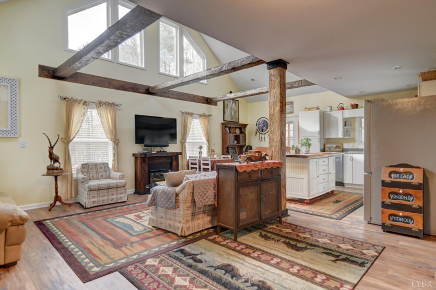 223 Cahas Mountain Road Boones Mill, VA 24065 - Photo 5 of 50 a living room with furniture a flat screen tv and a table