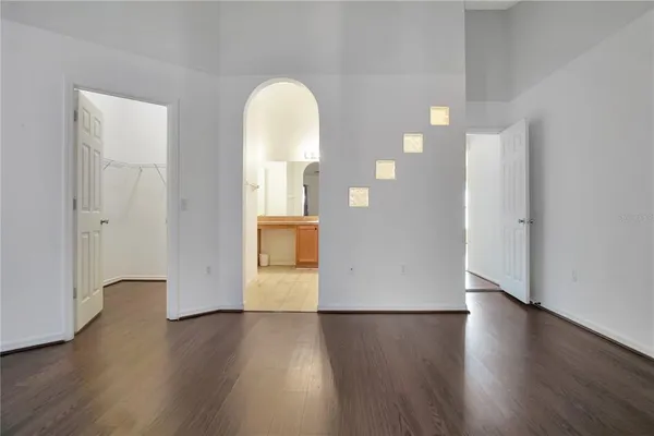 a view of empty room with wooden floor