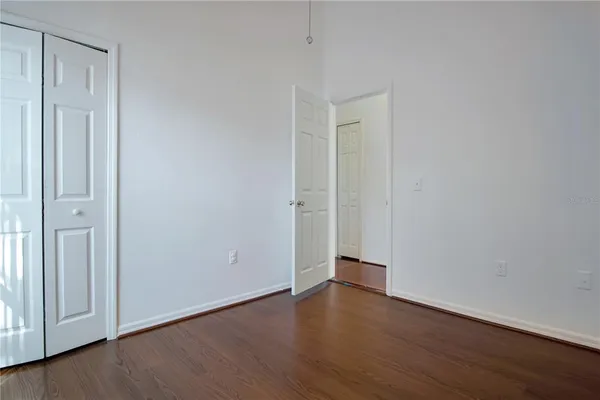 a view of an empty room with wooden floor