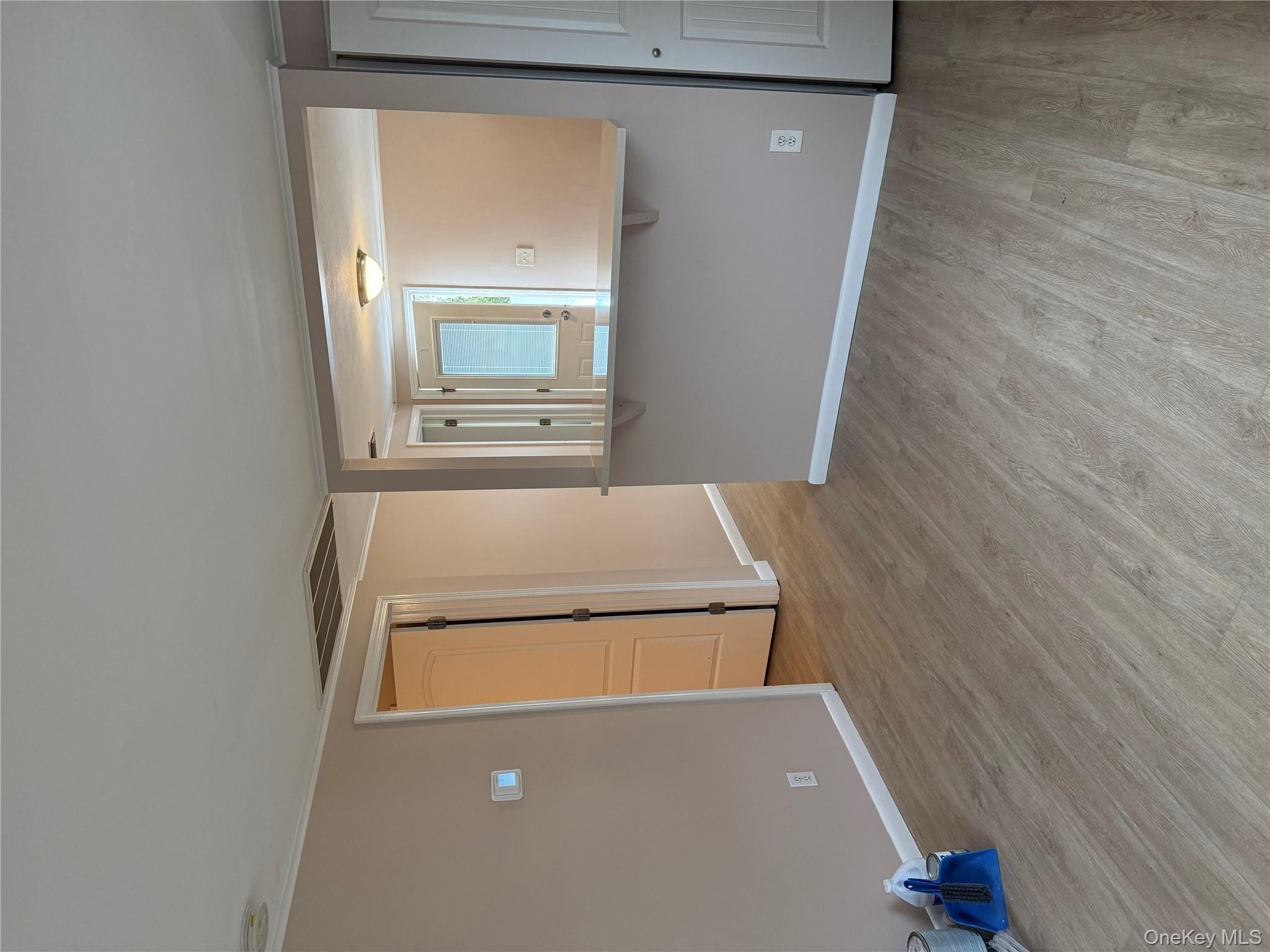 462 Moriches Road St. James, NY 11780 - Photo 8 of 17 Unfurnished room with light wood-style flooring and crown molding