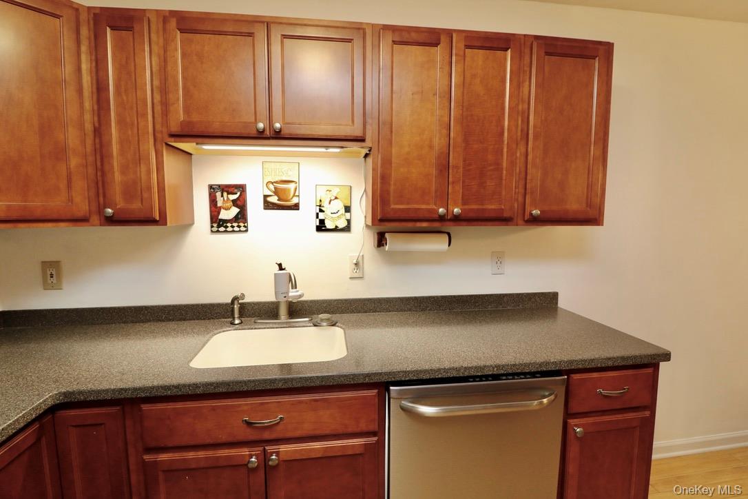 29 Lamplight Street Beacon, NY 12508 - Photo 14 of 22 a sink with granite countertop wooden cabinets