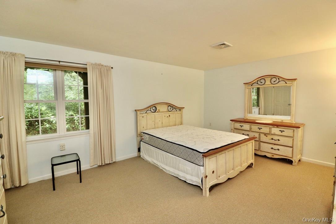 29 Lamplight Street Beacon, NY 12508 - Photo 15 of 22 a bedroom with a bed and a table in it