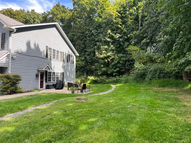 a view of a house with a yard and sitting area