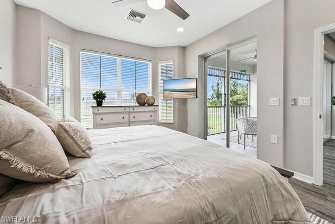 a large bed sitting in a bedroom next to a window