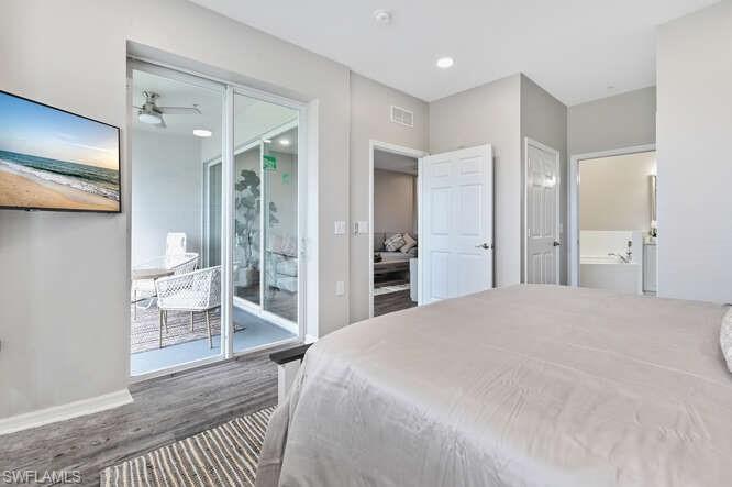 7935 Mahogany Run Lane, Unit 725 Naples, FL 34113 - Photo 20 of 27 a spacious bedroom with a bed and walk in closet