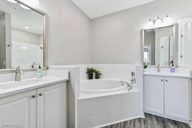 7935 Mahogany Run Lane, Unit 725 Naples, FL 34113 - Photo 22 of 27 a bathroom with a double vanity sink mirror and double