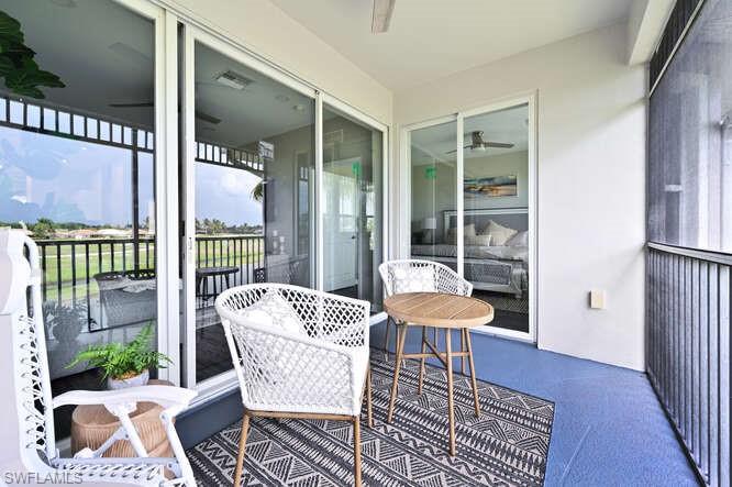 7935 Mahogany Run Lane, Unit 725 Naples, FL 34113 - Photo 25 of 27 a balcony with furniture and wooden floor