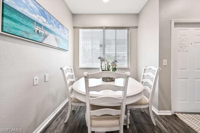 7935 Mahogany Run Lane, Unit 725 Naples, FL 34113 - Photo 4 of 27 a view of a dining room with furniture window and wooden floor
