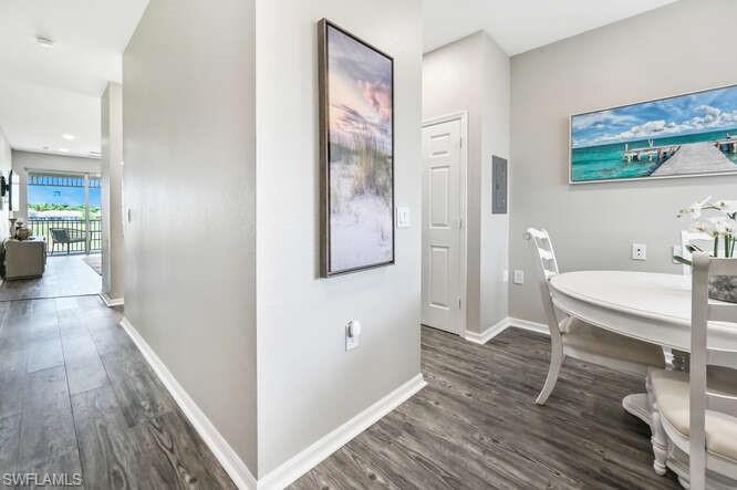 7935 Mahogany Run Lane, Unit 725 Naples, FL 34113 - Photo 6 of 27 a view of a hallway with furniture and wooden floor