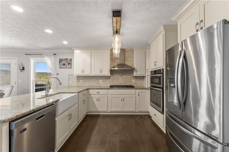4295 Porter Springs Road Dahlonega, GA 30533 - Photo 12 of 55 a kitchen with granite countertop a refrigerator sink and stove