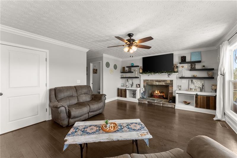 4295 Porter Springs Road Dahlonega, GA 30533 - Photo 17 of 55 a living room with furniture a flat screen tv and a fireplace