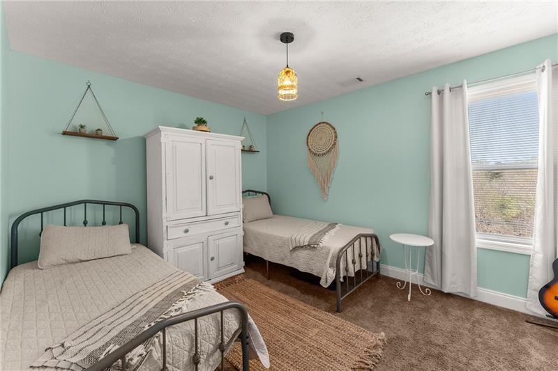 4295 Porter Springs Road Dahlonega, GA 30533 - Photo 21 of 55 a bedroom with a bed a chandelier and mirror