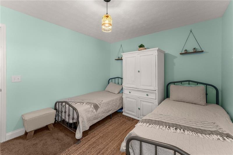 4295 Porter Springs Road Dahlonega, GA 30533 - Photo 23 of 55 a bedroom with a bed and a chandelier