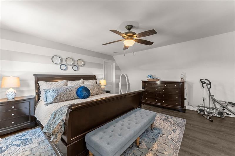 4295 Porter Springs Road Dahlonega, GA 30533 - Photo 27 of 55 a bedroom with a bed dresser and wooden floor