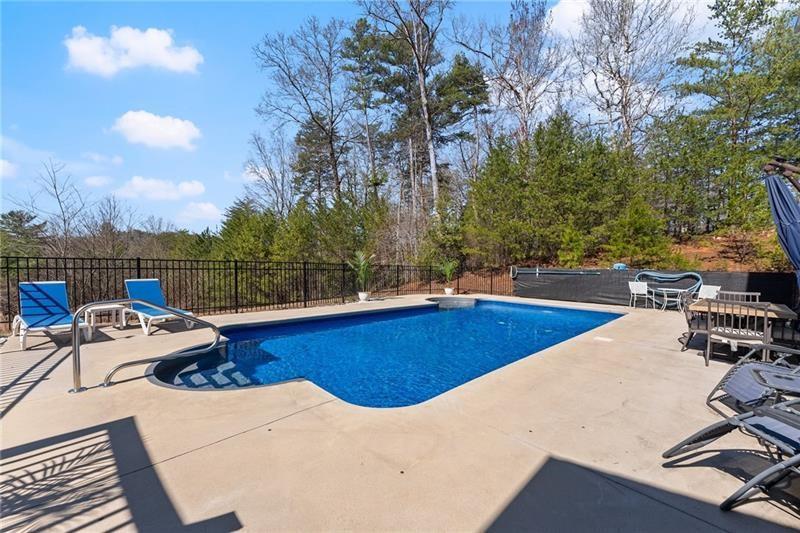 4295 Porter Springs Road Dahlonega, GA 30533 - Photo 38 of 55 a view of a swimming pool with lounge chairs