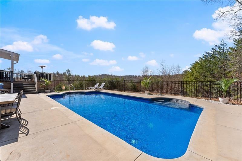 4295 Porter Springs Road Dahlonega, GA 30533 - Photo 39 of 55 a view of a swimming pool with a lounge chair
