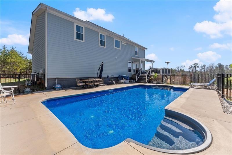 4295 Porter Springs Road Dahlonega, GA 30533 - Photo 40 of 55 a view of a swimming pool with an outdoor seating