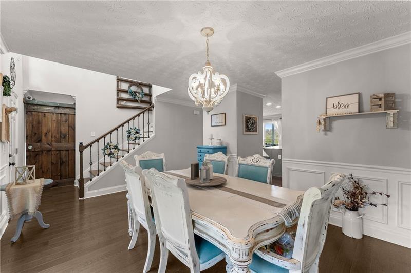 4295 Porter Springs Road Dahlonega, GA 30533 - Photo 7 of 55 a view of a dining room with furniture a chandelier and wooden floor