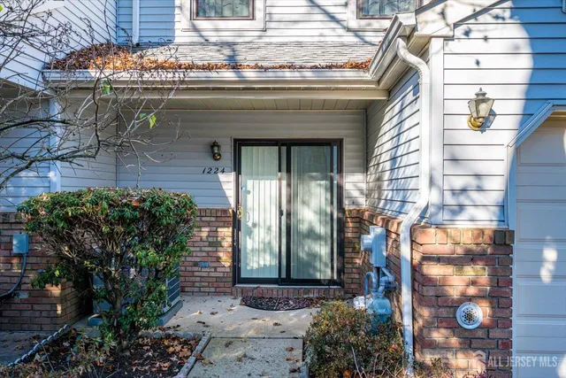 a front view of a house with outdoor seating and plants