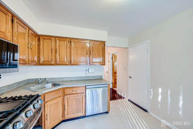a kitchen with stainless steel appliances granite countertop a stove a sink and dishwasher with cabinets