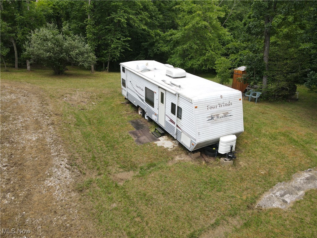 55202 Red Lane Road Cumberland, OH 43732 - Photo 5 of 11 View of subject property featuring a forest