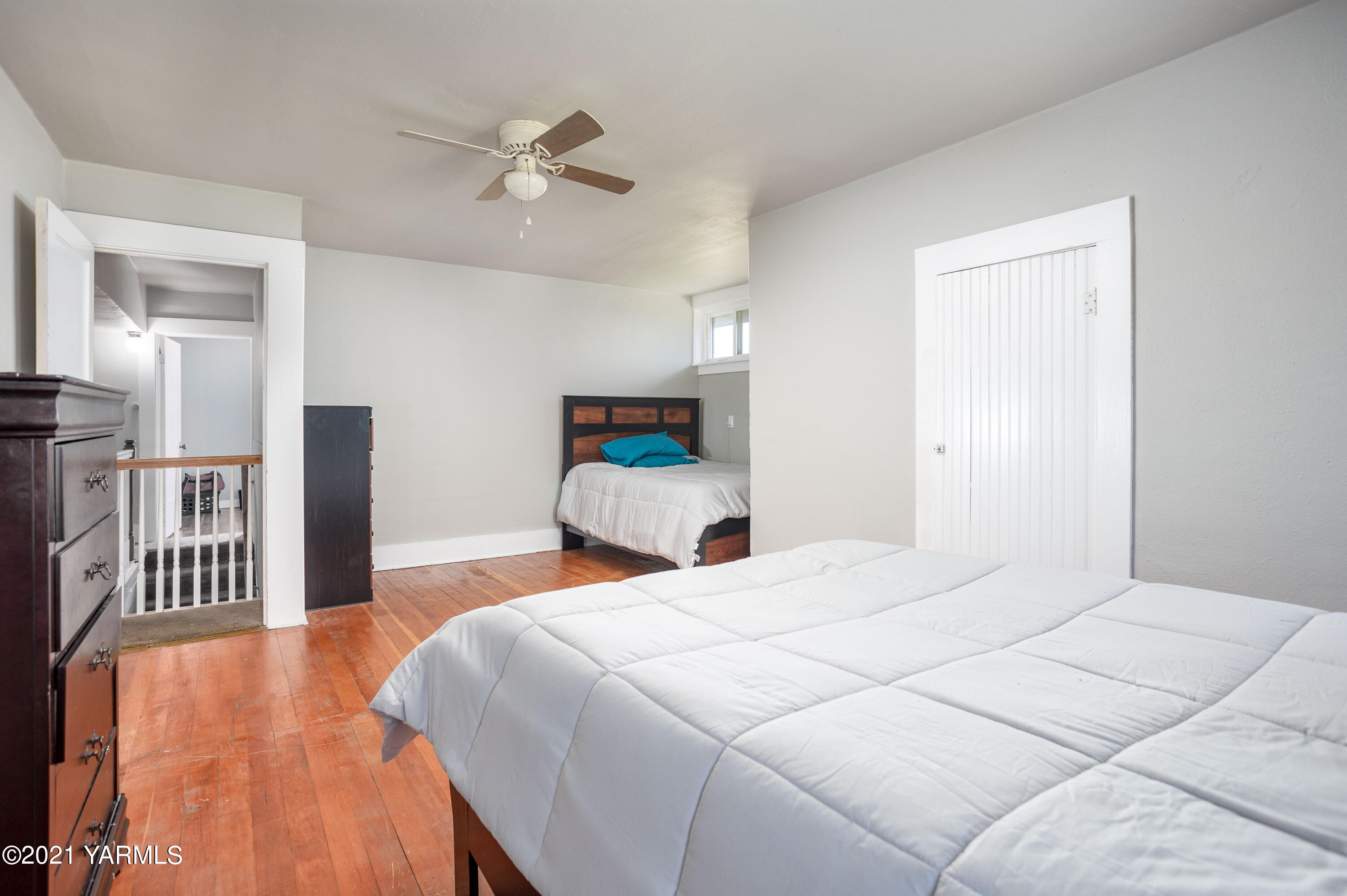 570 Chase Road Grandview, WA 98930 - Photo 16 of 42 a bedroom with a bed and a ceiling fan