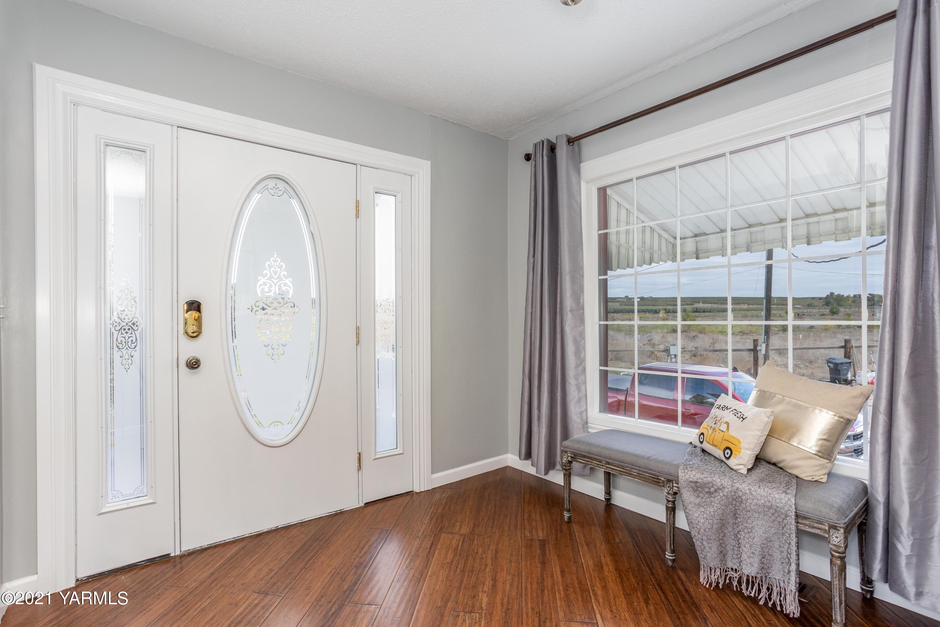 570 Chase Road Grandview, WA 98930 - Photo 4 of 42 a view of a room with wooden floor and windows