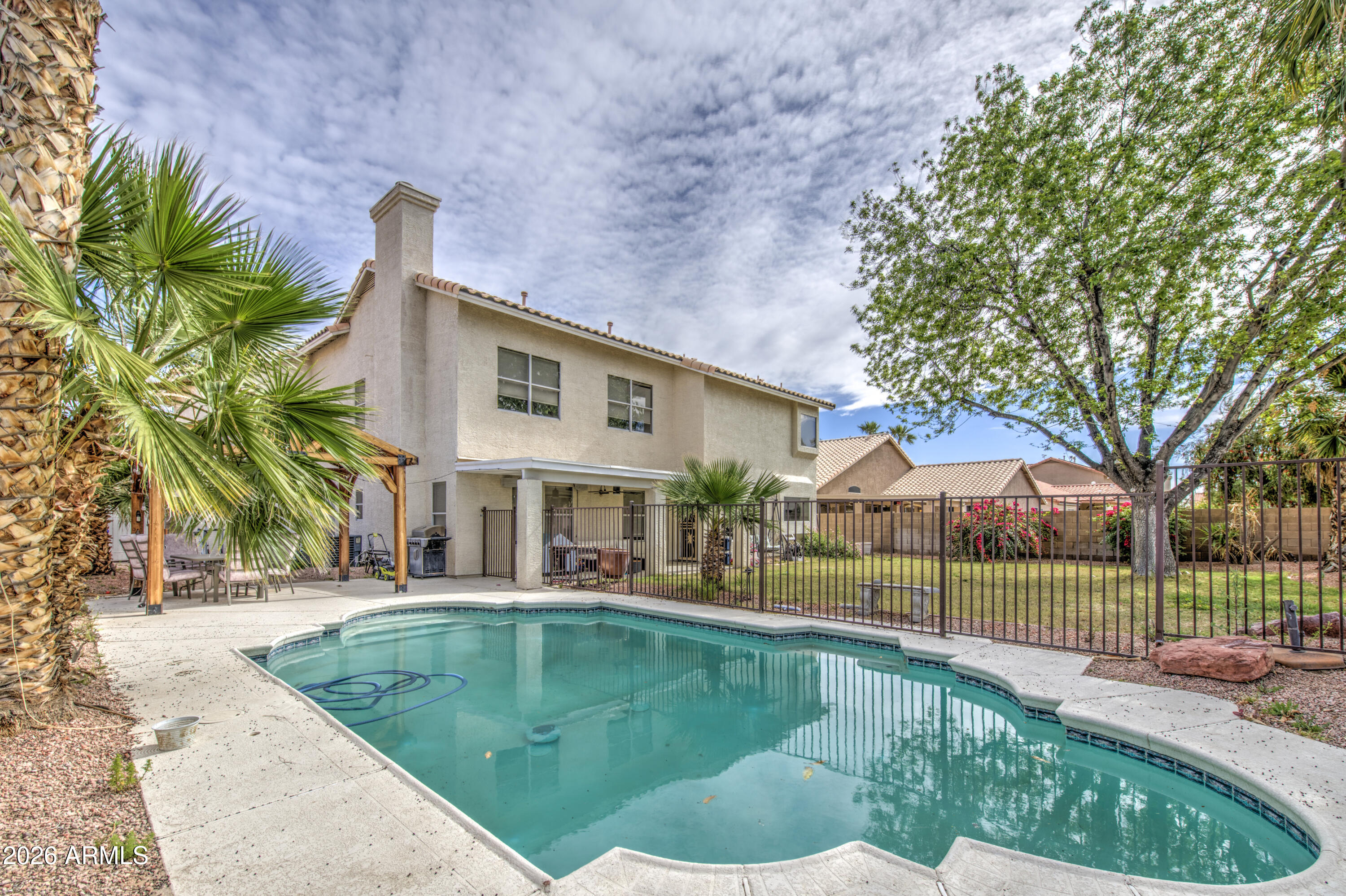 12403 West Monte Vista Road Avondale, AZ 85392 - Photo 52 of 63 a front view of a house with a yard table and chairs