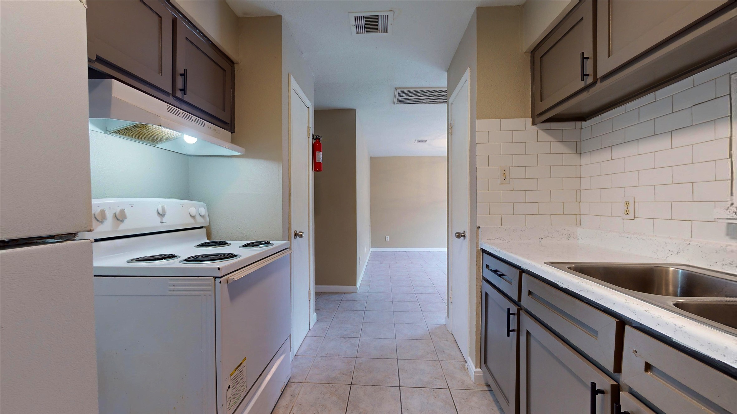 5017 Mallow Street Houston, TX 77033 - Photo 18 of 30 a kitchen that has a sink and a stove