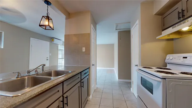 a kitchen with stainless steel appliances granite countertop a sink and a stove top oven