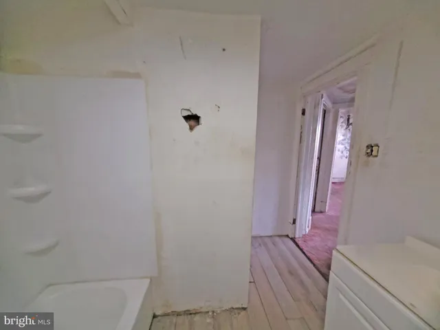 a view of an empty room with a fireplace