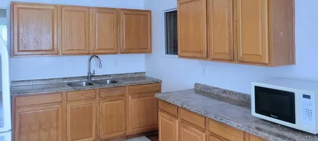 a living room with furniture potted plant and a window