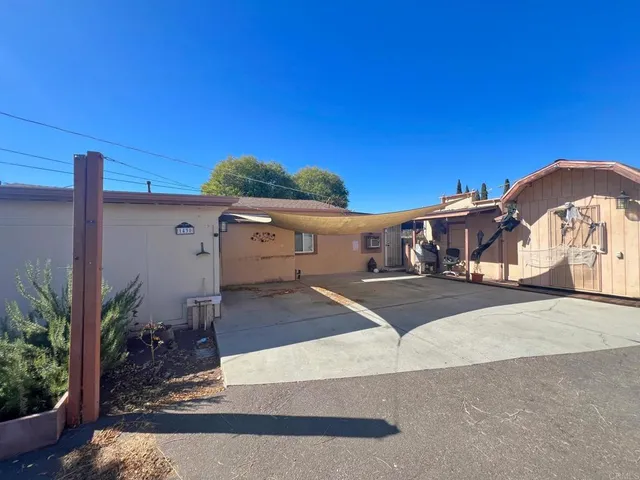 a view of a house with a yard and table