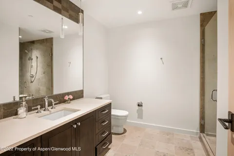 a bathroom with a sink vanity and a toilet