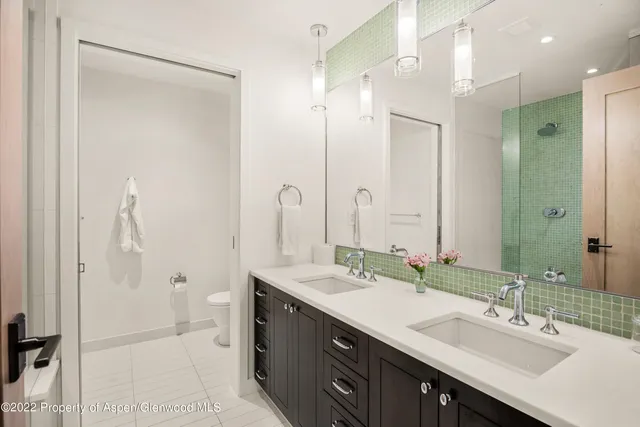a bathroom with a double vanity sink mirror and double