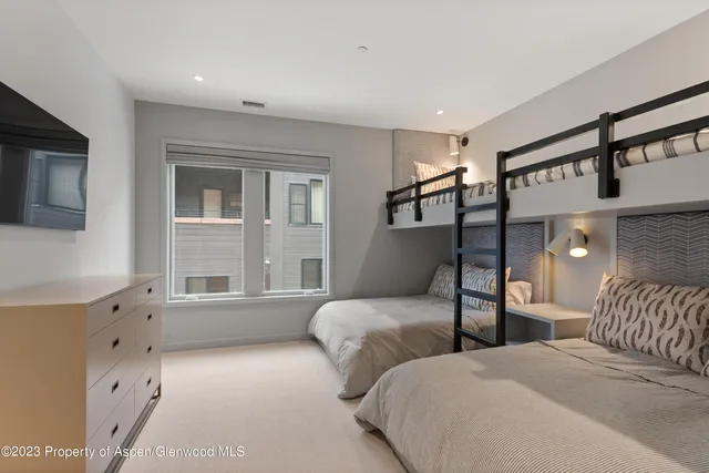 a bedroom with two beds and a window