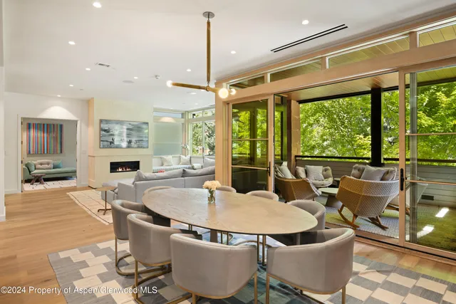 a dining room with furniture window and outdoor view